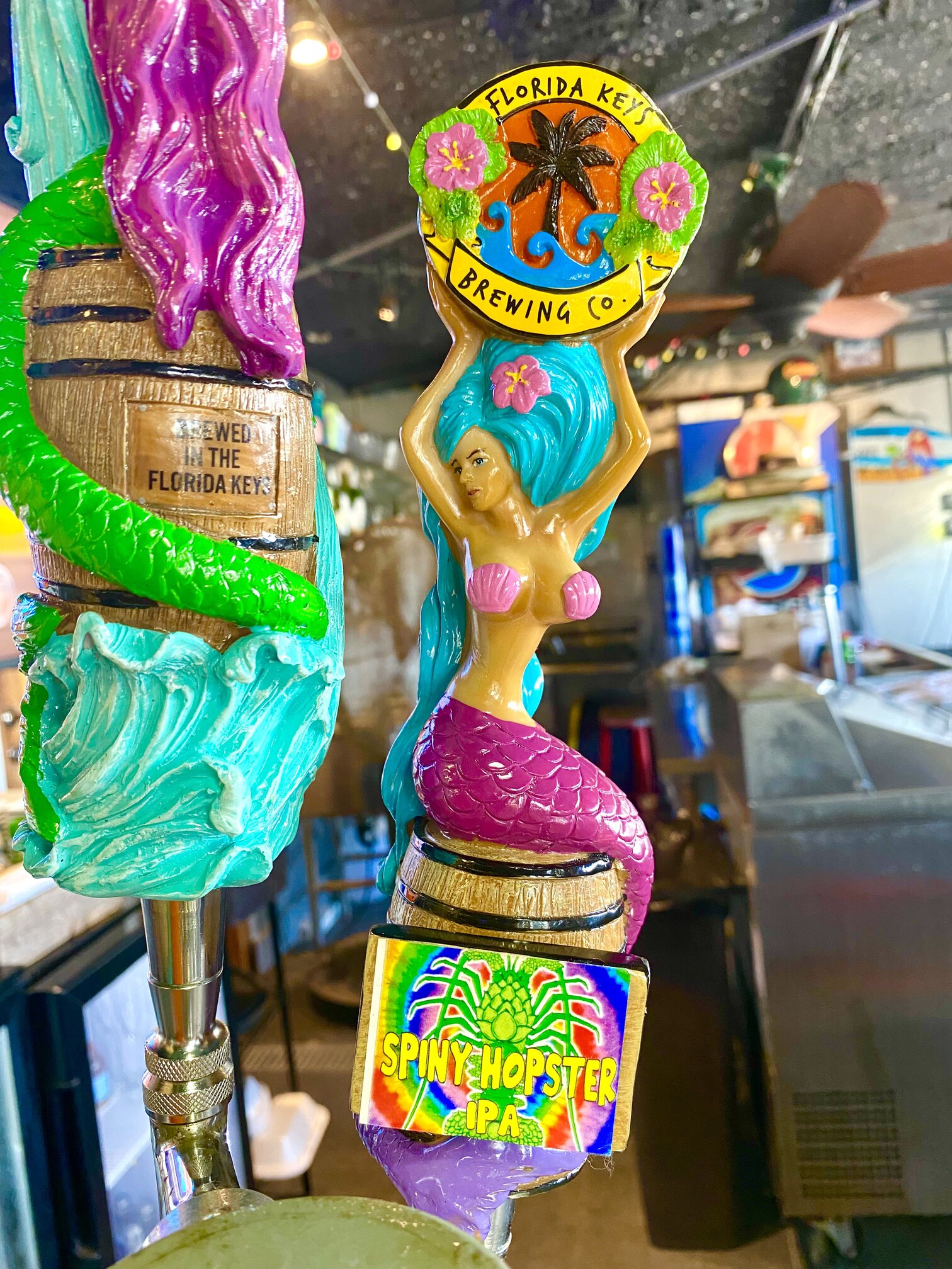 Whimsical mermaid tap handles at the bar.