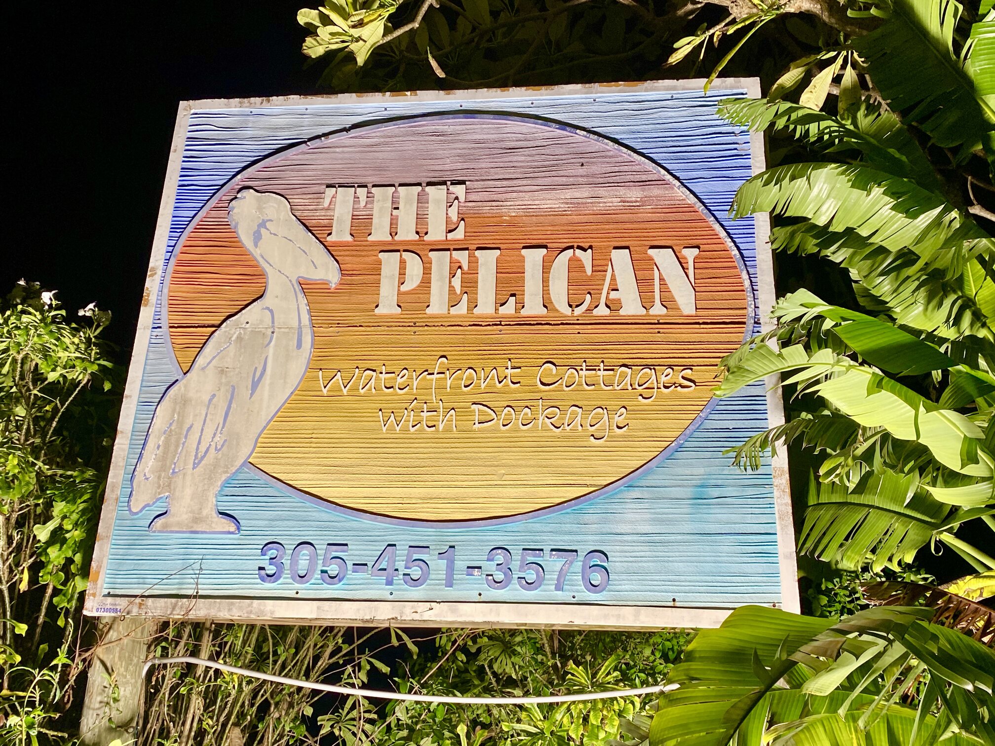The welcoming sign for The Pelican Waterfront Cottages.