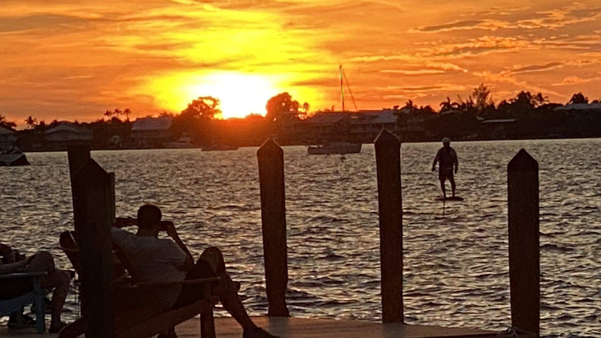 Guests gathering along the dock to watch sunset.