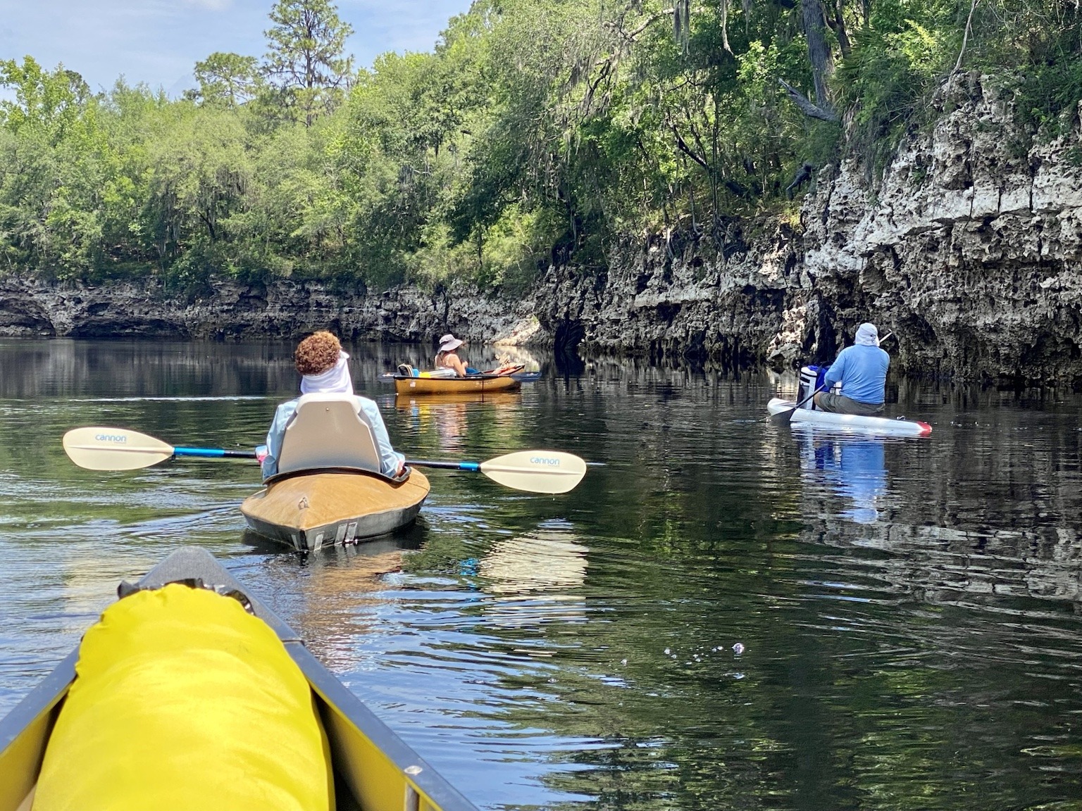 Our group moving downstream beside a rugged limestone shoreline.